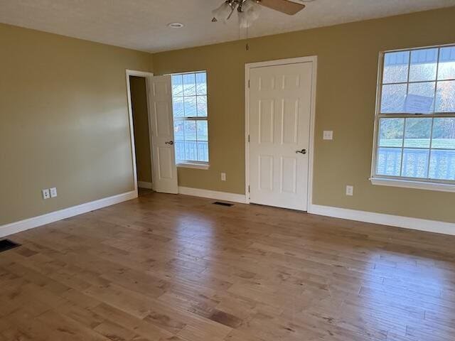 80 Panda Ln, Russell Springs, KY 42642 - empty room with plenty of natural light, ceiling fan, and wood finished floors