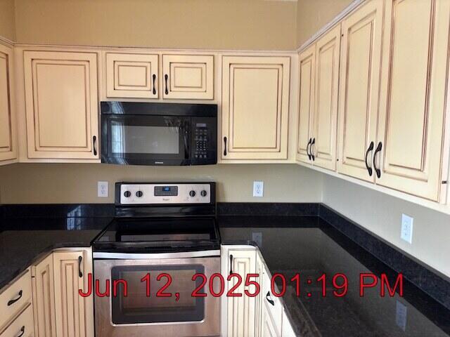 80 Panda Ln, Russell Springs, KY 42642 - kitchen with black microwave, stainless steel electric range oven, cream cabinetry, and dark countertops