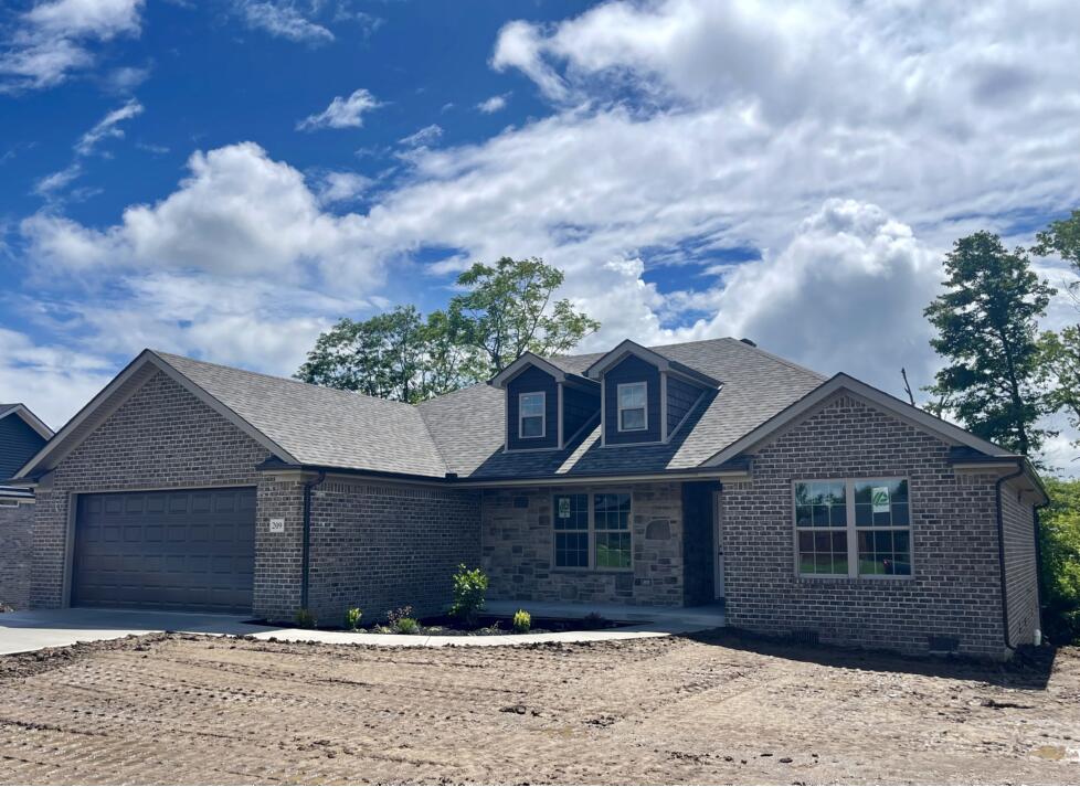 209 Patriot Trl, Berea, KY 40403 - view of front of home featuring a garage, brick siding, concrete driveway, and roof with shingles