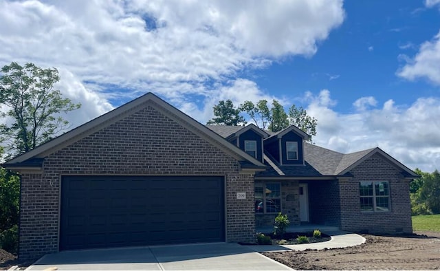 209 Patriot Trl, Berea, KY 40403 - view of front of house with brick siding, a garage, driveway, and covered porch