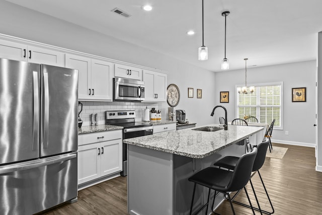 111 Kara Bryn Cv, Georgetown, KY 40324 - kitchen featuring stainless steel appliances, white cabinetry, decorative backsplash, dark wood-type flooring, and recessed lighting