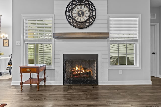 111 Kara Bryn Cv, Georgetown, KY 40324 - detailed view of a lit fireplace, wood finished floors, and a chandelier