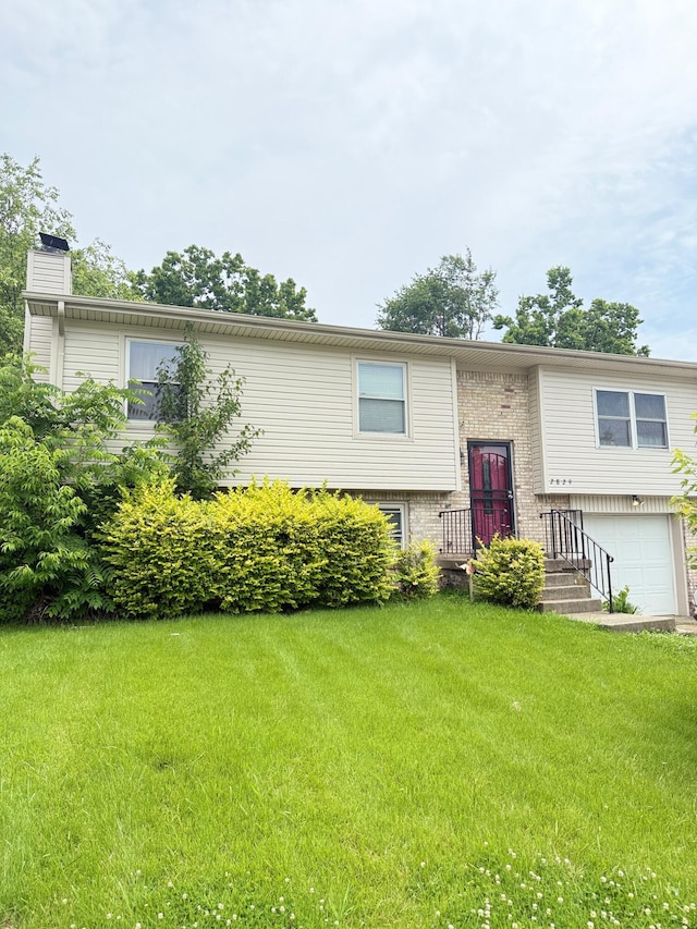 2829 Easthills Dr, Lexington, KY 40517 - bi-level home featuring a chimney, a garage, a front lawn, and brick siding
