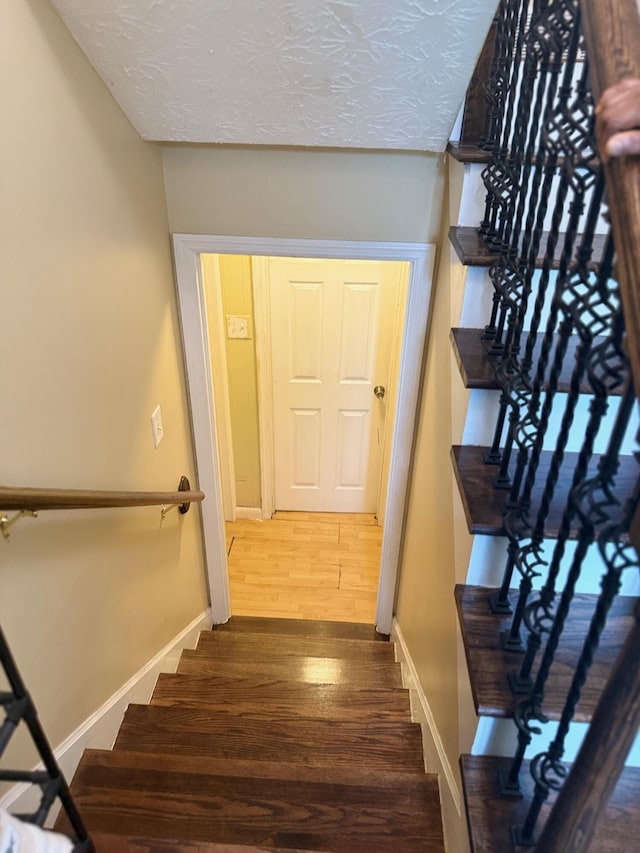 2829 Easthills Dr, Lexington, KY 40517 - staircase with wood finished floors and a textured ceiling