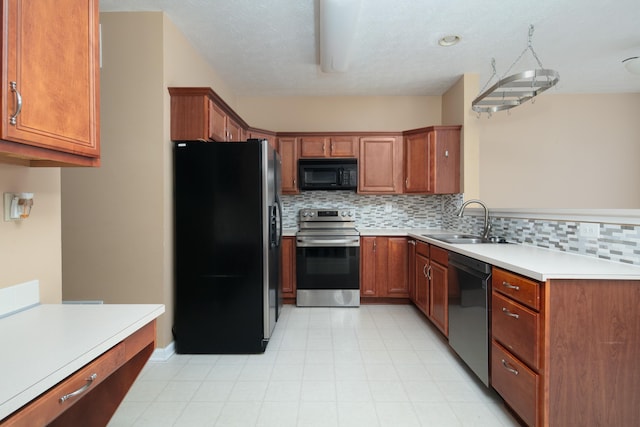 1204 Aldridge Way, Lexington, KY 40515 - kitchen featuring appliances with stainless steel finishes, backsplash, brown cabinets, light countertops, and a peninsula