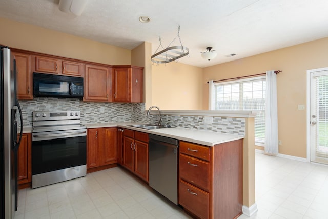 1204 Aldridge Way, Lexington, KY 40515 - kitchen featuring appliances with stainless steel finishes, a peninsula, brown cabinets, decorative backsplash, and light countertops