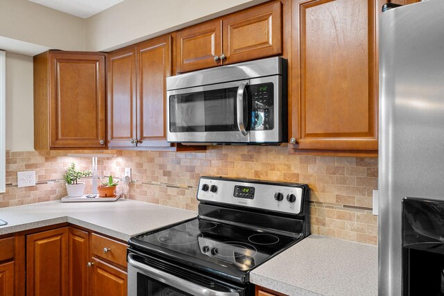 441 Cromwell Way, Lexington, KY 40503 - kitchen with stainless steel appliances, brown cabinets, light countertops, and decorative backsplash