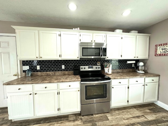 51 Stony Brook Dr, Corbin, KY 40701 - kitchen with stainless steel appliances, white cabinetry, backsplash, and recessed lighting