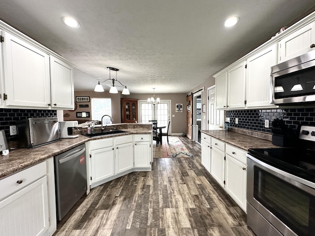 51 Stony Brook Dr, Corbin, KY 40701 - kitchen featuring stainless steel appliances, a peninsula, a chandelier, white cabinets, and recessed lighting