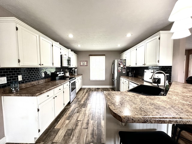 51 Stony Brook Dr, Corbin, KY 40701 - kitchen featuring appliances with stainless steel finishes, dark wood-style flooring, white cabinetry, and recessed lighting