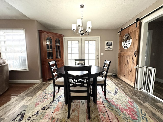 51 Stony Brook Dr, Corbin, KY 40701 - dining area featuring a chandelier, wood finished floors, a textured ceiling, and a barn door
