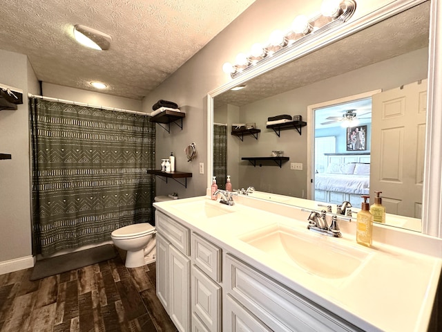 51 Stony Brook Dr, Corbin, KY 40701 - bathroom featuring double vanity, wood finished floors, a textured ceiling, connected bathroom, and ceiling fan