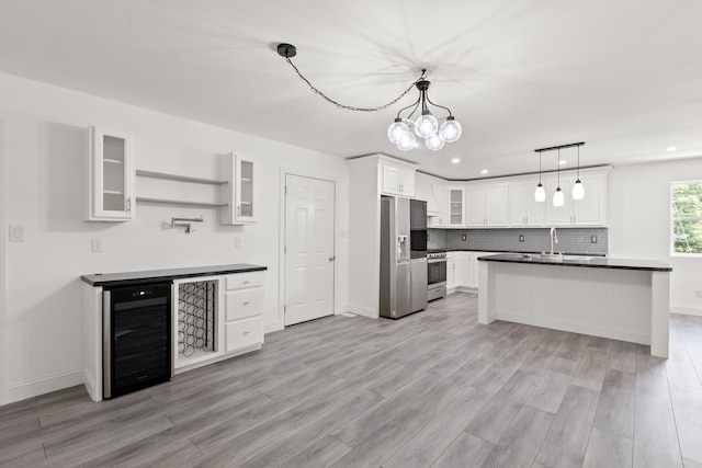 117 S Cumberland St, Berea, KY 40403 - kitchen featuring beverage cooler, appliances with stainless steel finishes, dark countertops, light wood-type flooring, and recessed lighting
