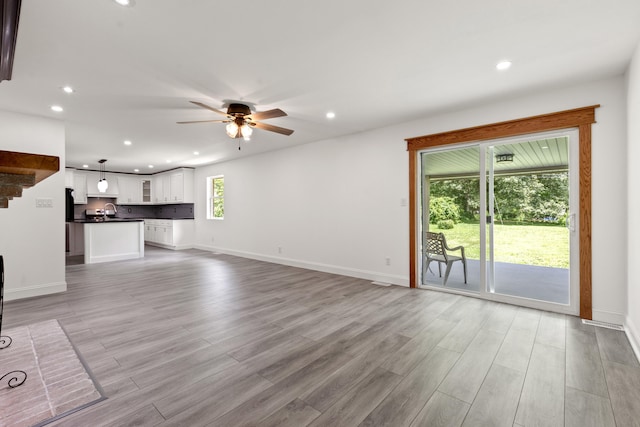 117 S Cumberland St, Berea, KY 40403 - unfurnished living room featuring ceiling fan, recessed lighting, and light wood-style flooring