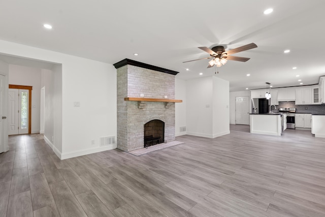 117 S Cumberland St, Berea, KY 40403 - unfurnished living room featuring recessed lighting, ceiling fan, light wood finished floors, and a large fireplace