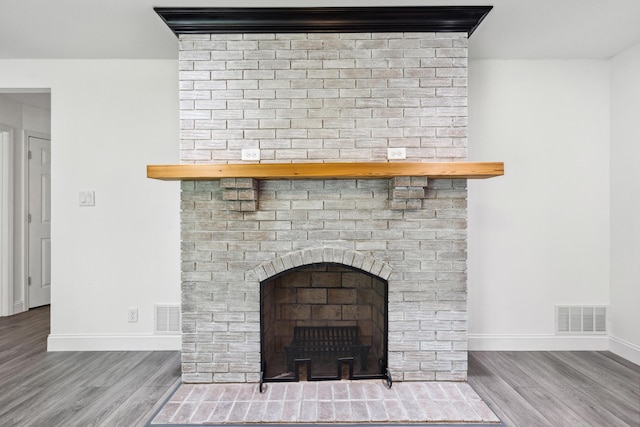 117 S Cumberland St, Berea, KY 40403 - detailed view of wood finished floors and a brick fireplace