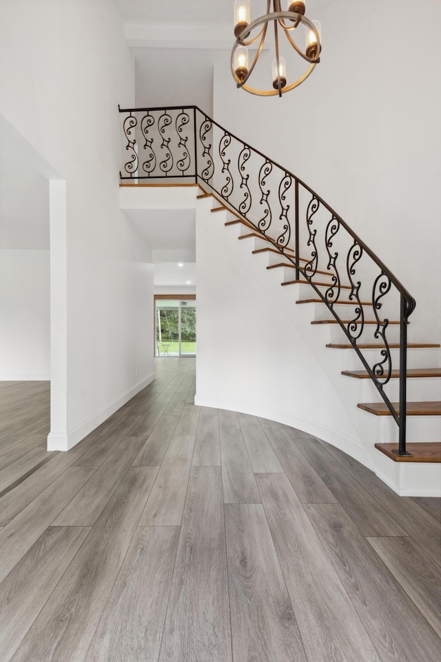 117 S Cumberland St, Berea, KY 40403 - staircase featuring a chandelier, wood finished floors, and a towering ceiling