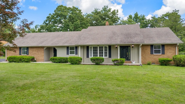 117 S Cumberland St, Berea, KY 40403 - view of front of property featuring brick siding, a front yard, and a chimney