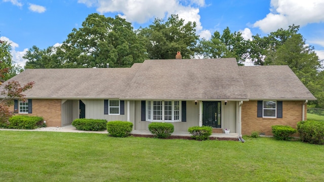 117 S Cumberland St, Berea, KY 40403 - view of front of house featuring roof with shingles, a front lawn, and brick siding