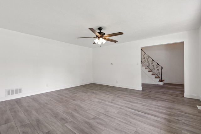 117 S Cumberland St, Berea, KY 40403 - unfurnished room with ceiling fan, wood finished floors, and stairs