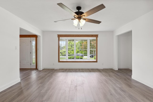117 S Cumberland St, Berea, KY 40403 - unfurnished living room featuring wood finished floors and a ceiling fan