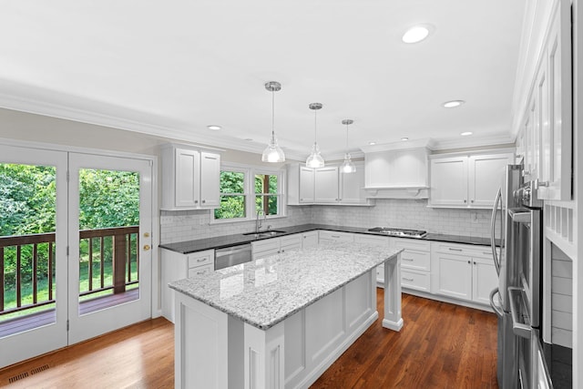 3605 Afton Pl, Lexington, KY 40515 - kitchen featuring a center island, appliances with stainless steel finishes, white cabinetry, tasteful backsplash, and ornamental molding