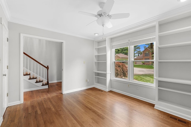 3605 Afton Pl, Lexington, KY 40515 - empty room with stairs, wood finished floors, built in features, ornamental molding, and a ceiling fan