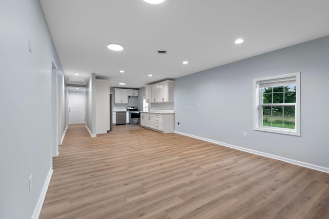 423 Perryville St, Harrodsburg, KY 40330 - unfurnished living room featuring light wood-style flooring, recessed lighting, and attic access