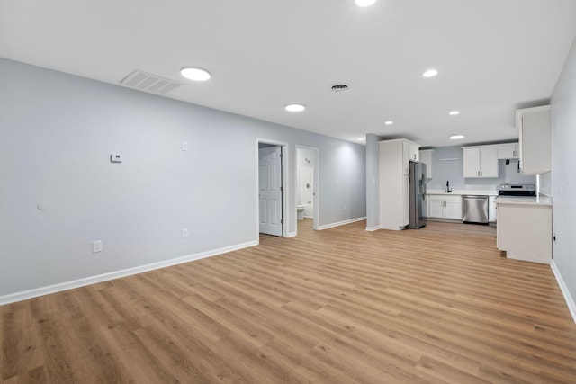 423 Perryville St, Harrodsburg, KY 40330 - unfurnished living room with light wood-style flooring and recessed lighting