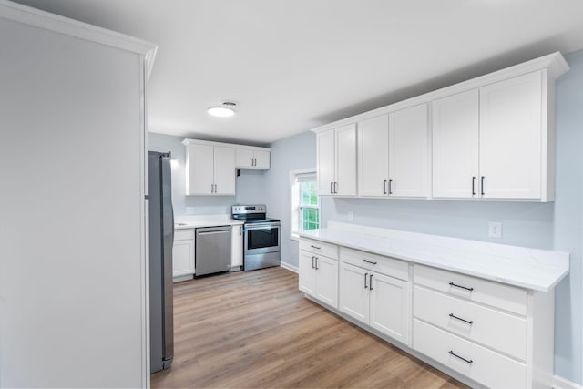 423 Perryville St, Harrodsburg, KY 40330 - kitchen with appliances with stainless steel finishes, white cabinetry, light wood-style floors, and light stone counters