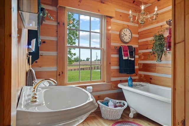 5045 Van Meter Rd, Winchester, KY 40391 - full bathroom with a freestanding bath, plenty of natural light, wood walls, wood finished floors, and a chandelier