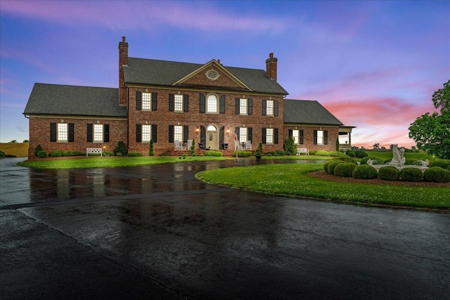 5045 Van Meter Rd, Winchester, KY 40391 - colonial house featuring a chimney, curved driveway, a front yard, and brick siding