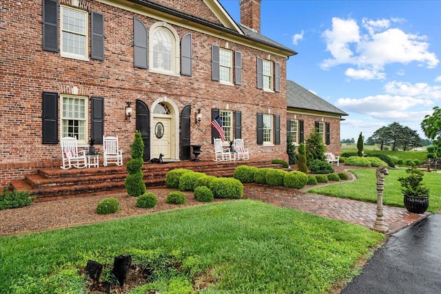5045 Van Meter Rd, Winchester, KY 40391 - colonial house featuring a chimney, brick siding, a front yard, and a shingled roof