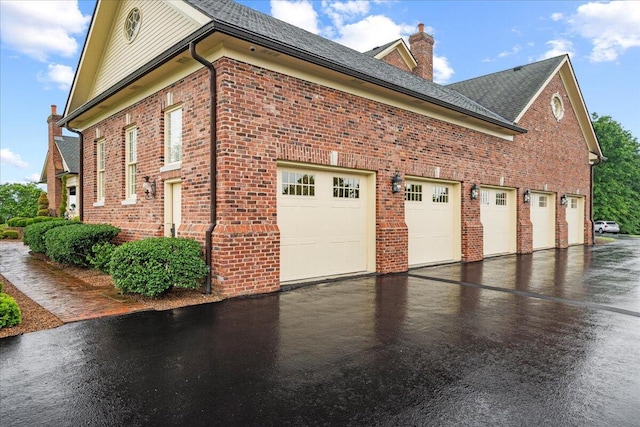 5045 Van Meter Rd, Winchester, KY 40391 - view of property exterior featuring brick siding, a chimney, asphalt driveway, and a garage