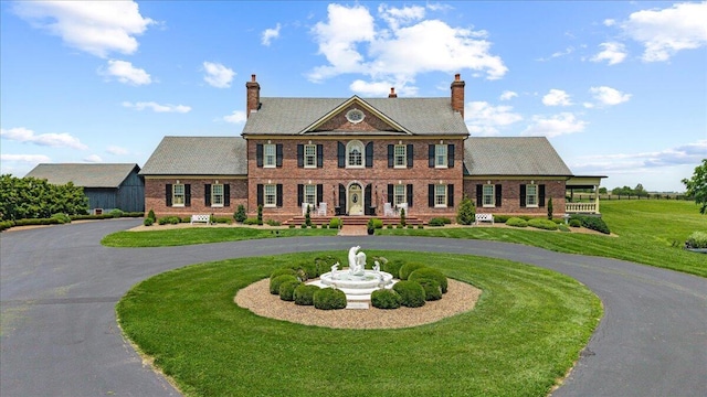 5045 Van Meter Rd, Winchester, KY 40391 - colonial-style house featuring curved driveway, brick siding, a front lawn, and a chimney