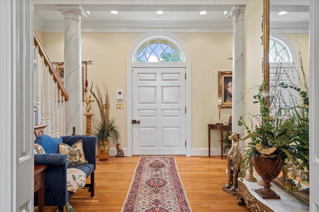 5045 Van Meter Rd, Winchester, KY 40391 - foyer with decorative columns, light wood finished floors, crown molding, stairs, and recessed lighting