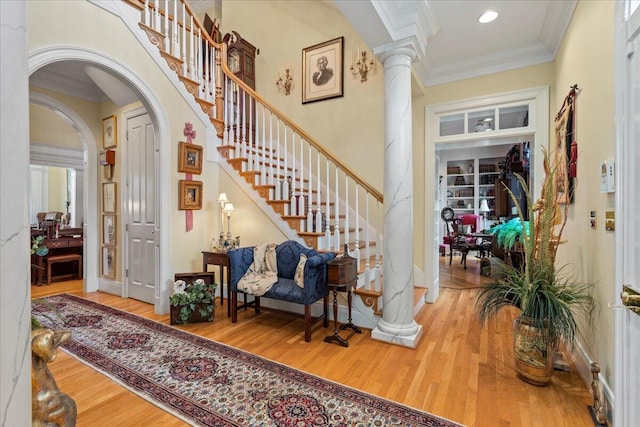 5045 Van Meter Rd, Winchester, KY 40391 - foyer featuring wood finished floors, ornate columns, arched walkways, crown molding, and stairway