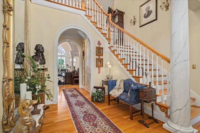 5045 Van Meter Rd, Winchester, KY 40391 - foyer entrance featuring arched walkways, a high ceiling, wood finished floors, stairway, and ornate columns