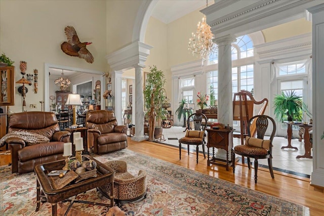 5045 Van Meter Rd, Winchester, KY 40391 - living area featuring ornate columns, a high ceiling, a chandelier, wood finished floors, and arched walkways