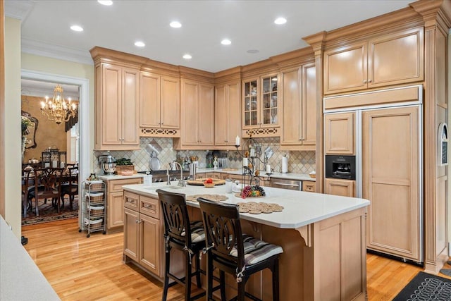 5045 Van Meter Rd, Winchester, KY 40391 - kitchen with paneled built in fridge, light countertops, crown molding, a chandelier, and light wood finished floors