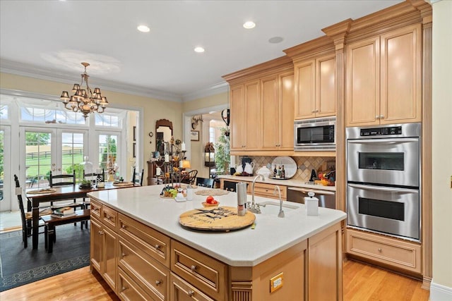 5045 Van Meter Rd, Winchester, KY 40391 - kitchen featuring appliances with stainless steel finishes, a chandelier, light wood finished floors, light countertops, and healthy amount of natural light
