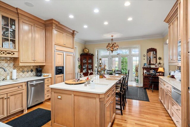5045 Van Meter Rd, Winchester, KY 40391 - kitchen featuring dishwasher, a warming drawer, paneled fridge, light wood-style floors, and crown molding