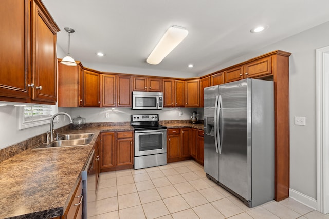 165 Rolling Meadows Dr, Stanford, KY 40484 - kitchen with appliances with stainless steel finishes, dark countertops, brown cabinetry, light tile patterned floors, and recessed lighting
