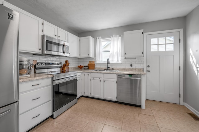 210 Taylorsville Trl, Georgetown, KY 40324 - kitchen featuring appliances with stainless steel finishes, plenty of natural light, decorative backsplash, and white cabinetry
