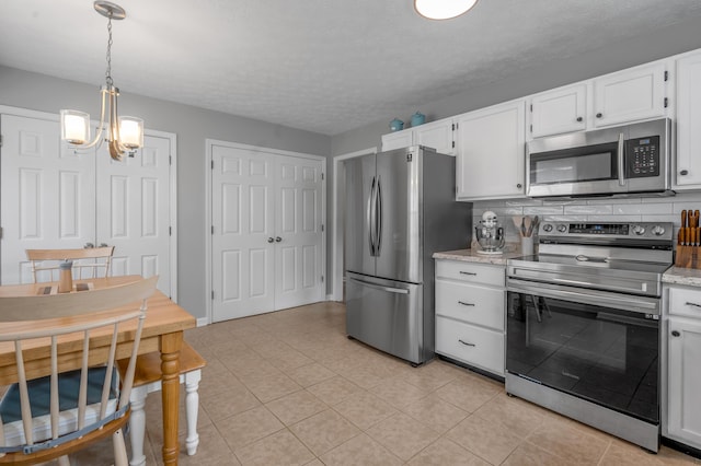 210 Taylorsville Trl, Georgetown, KY 40324 - kitchen featuring appliances with stainless steel finishes, a chandelier, white cabinetry, light tile patterned floors, and a textured ceiling