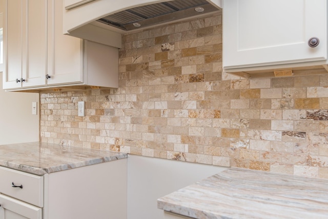 4185 Buttermilk Rd, Lexington, KY 40509 - kitchen featuring island exhaust hood, tasteful backsplash, white cabinets, and light stone counters