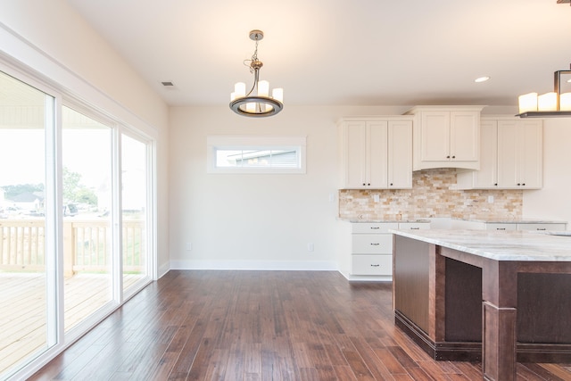 4185 Buttermilk Rd, Lexington, KY 40509 - kitchen with healthy amount of natural light, hanging light fixtures, white cabinets, tasteful backsplash, and recessed lighting