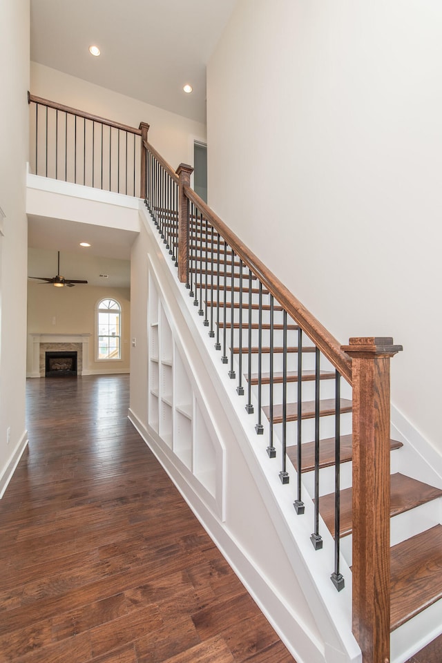 4185 Buttermilk Rd, Lexington, KY 40509 - stairway with wood finished floors, recessed lighting, a ceiling fan, a fireplace, and a high ceiling