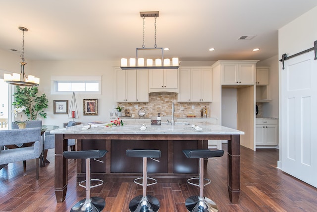 4185 Buttermilk Rd, Lexington, KY 40509 - kitchen featuring a barn door, decorative backsplash, dark wood finished floors, and recessed lighting