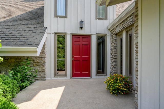 2968 Delong Rd, Lexington, KY 40515 - doorway to property featuring stone siding, board and batten siding, and a shingled roof